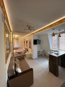 a living room with a couch and a bed at Central Park Rentals in Chişinău