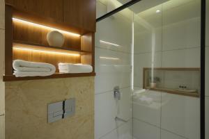 a bathroom with a shower and a glass shower stall at Royale Suites - 1 BHK Serviced Apartment in Kadayirippu