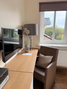 TV a/nebo společenská místnost v ubytování Dat Lütte Hus
