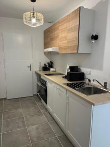 a kitchen with a sink and a counter top at Gite du Lac T4 in Vieux-Boucau-les-Bains +2 photos