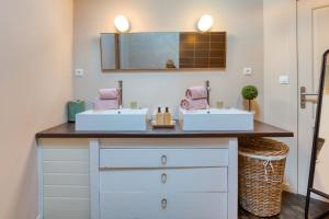 a bathroom with two sinks and a mirror at Calmacé in Gignac +16 photos