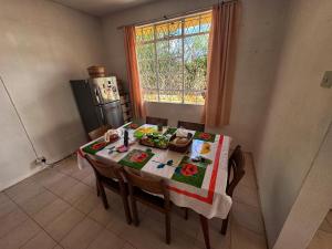 a kitchen with a table with a table cloth on it at 毛里求斯民宿 in Roche Bois