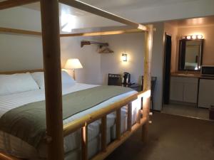 a bedroom with a bed with a wooden frame at Gateway Inn in Lyman