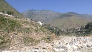 a view of a rocky mountain with houses on it at Abu Dhabi Palace in Dargai