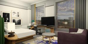 a bedroom with a bed and a desk and a tv at The Waymark Chattanooga, Tapestry Collection By Hilton in Chattanooga