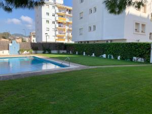 a swimming pool in a yard next to a building at Sitges Spaces Oasis Penthouse 3 Bedroom, 2 Bathroom, Terrace, Pool, Sleeps up to 6 in Sitges