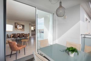 a kitchen and dining room with a table and chairs at Sitges Spaces Oasis Penthouse 3 Bedroom, 2 Bathroom, Terrace, Pool, Sleeps up to 6 in Sitges