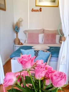 a room with a bed with pink roses at Casa 1895- where history meets comfort in Žalec
