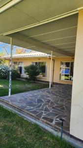 a building with a stone patio in front of it at The Hamlet House in Prince Alfreds Hamlet