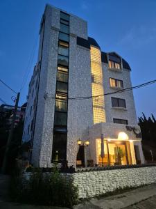 a tall stone building with lights on at Hotel Boreum in Sach'ŏnjil-li