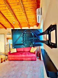 AmenoにあるHome and garden nestled in Amenoのリビングルーム(赤いソファ、薄型テレビ付)