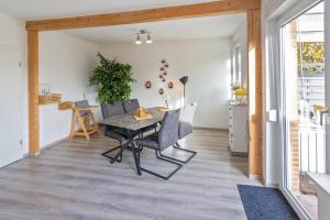 a dining room with a table and chairs at Deichgraf in Dornumersiel