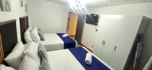 a bedroom with a bed and a white cabinet at Casa Mariscal in Guatemala
