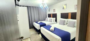 a hotel room with two beds and a window at Casa Mariscal in Guatemala