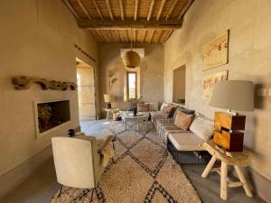 a living room with a couch and a fireplace at Dar faracha in Ouarzazate