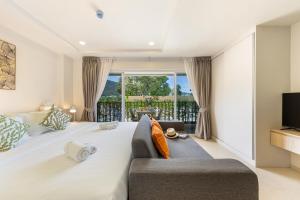 Postel nebo postele na pokoji v ubytování The Terraza Studio Apartment A104 + 39 fotografií