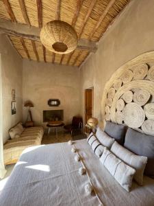a bedroom with a large bed and a couch at Dar faracha in Ouarzazate