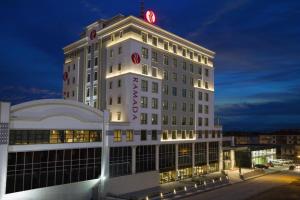 a white building with a sign on top of it at Ramada By Wyndham Elazığ in Elazığ