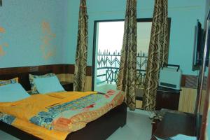 a bedroom with a bed with curtains and a window at Mount heaven Hotel in Murree