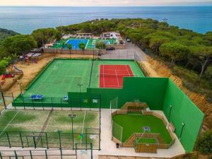 an aerial view of a tennis court next to the ocean at Camping Roca Grossa in Calella