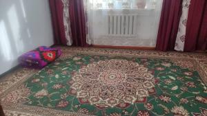 a rug on the floor in a room with a window at Гостевой дом Жылдыз Курак in Orto-Saz