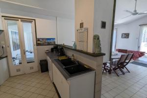 a kitchen with a sink and a dining room at Spacious nest with terrace near the beach in Talmont-Saint-Hilaire