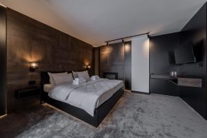 a bedroom with a large bed and wooden walls at Rei 2 in Belgrade