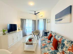 a living room with a couch and a tv at Luxury Stays By The Beach Goa in Benaulim