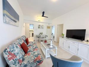 a living room with a couch and a tv at Luxury Stays By The Beach Goa in Benaulim