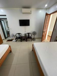 a room with two beds and a flat screen tv at Manh Vuong Hotel &Travel in Cat Ba +35 photos
