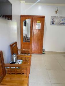 a room with two chairs and a table and a television at Manh Vuong Hotel &Travel in Cat Ba