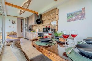 a dining room with a table with wine glasses at Vineyard cottage Pri mali luži in Trebelno