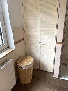 un bagno con uno sgabello di vimini e un armadio di Messe Premium Apartment a Dusseldorf
