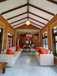 a large living room with couches and a table at Divulgaha Gedara Boutique Hotel in Anuradhapura