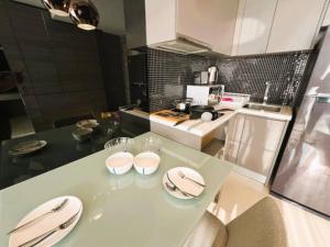 a kitchen with a table with two plates on it at Seaphere Residence by Prop Hopper in Na Jomtien
