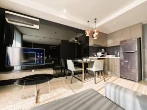 a living room with a table and a kitchen at Seaphere Residence by Prop Hopper in Na Jomtien