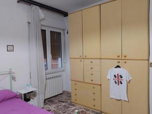a bedroom with a white shirt hanging on a cabinet at Casa Muscas in Iglesias