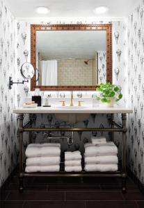 a bathroom with a sink and a mirror at Graduate by Hilton State College in State College