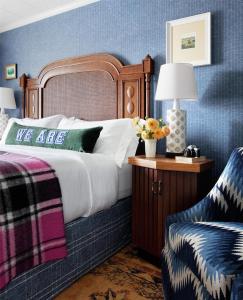 a bedroom with a bed and a chair at Graduate by Hilton State College in State College