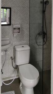 a bathroom with a toilet and a sink at Mul House Syariah in Bedakah