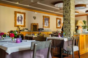 a restaurant with tables and chairs in a room at Hotel Bristol in Fiumalbo