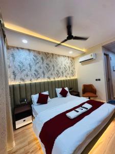 a bedroom with a large bed with red pillows at Anmolairbnb in Greater Noida