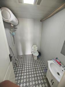 a small bathroom with a toilet and a sink at Suhe Homestay in Nanjing