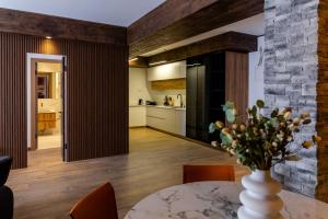 a kitchen and dining room with a vase of flowers on a table at New Gudauri Ski4Life in Gudauri