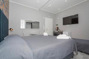 a bedroom with a large bed and a tv at Dolce Relax in Catania
