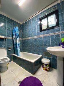 a bathroom with a tub and a toilet and a sink at HOTEL BADINCA Alojamento Low Cost in Bissau avenida FRANCISCO MENDES in Bissau +30 photos