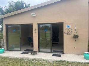 a house with sliding glass doors and a patio at Imvubu Chalet in Sodwana Bay
