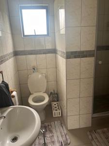 a bathroom with a toilet and a sink and a shower at Imvubu Chalet in Sodwana Bay +7 photos