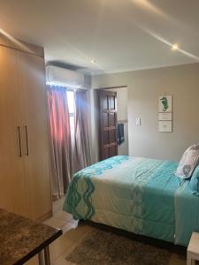 a bedroom with a bed and a window at Imvubu Chalet in Sodwana Bay
