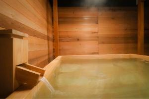 a jacuzzi tub in a wooden room at Fuji Elegance Hotel in Yamanakako